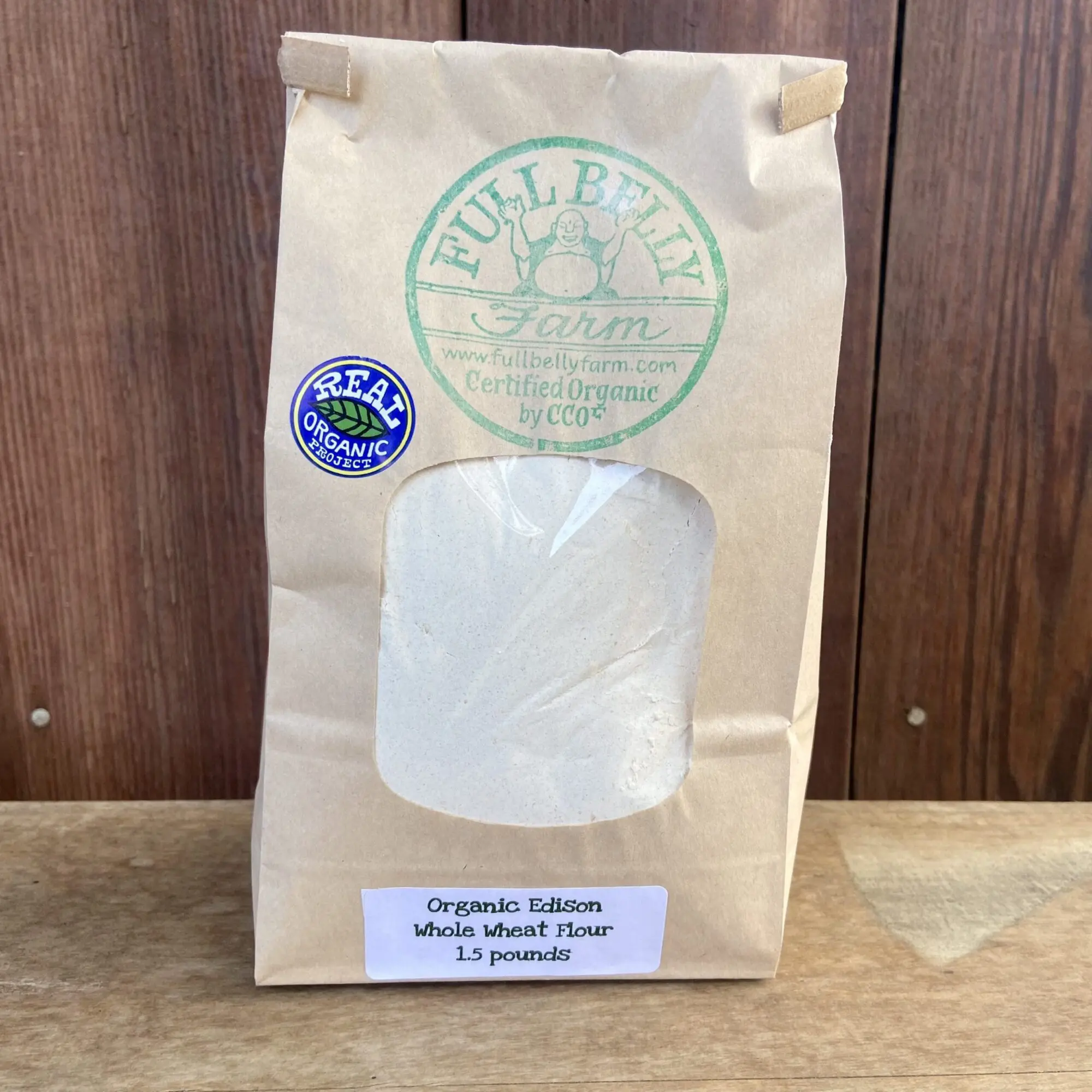 A 1.5-pound bag of "Full Belly Farm Organic Edison Whole Wheat Flour" with "REAL ORGANIC PROJECT" and "Certified Organic by CCOF" labels.