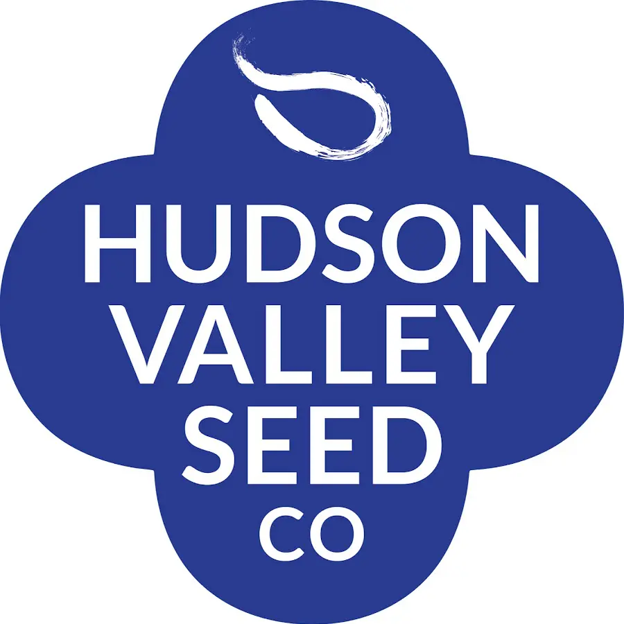 Blue quatrefoil logo for "Hudson Valley Seed Co" with a white stylized seed.