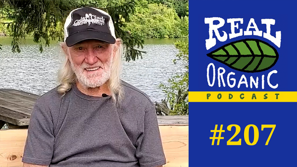 Will Allen smiles from a picnic table in front of the Connecticut River in East Thetford VT.