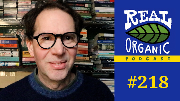 Matthew Ingram, a man with dark hair and round glasses, smiles in front of bookshelves for the "Real Organic Podcast #218."