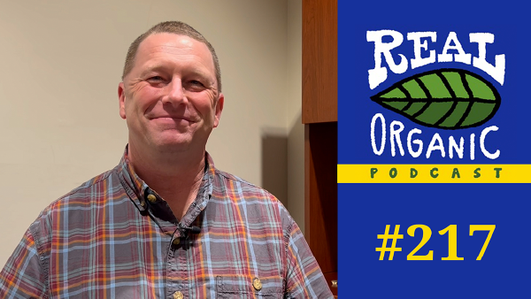 Scott Myers, a smiling man wearing a plaid shirt, is featured for the "Real Organic Podcast #217."
