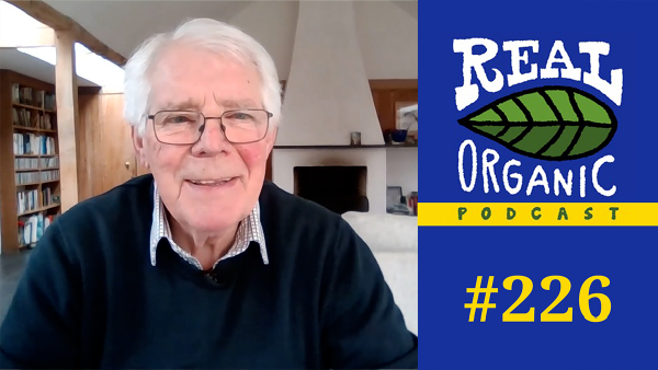 The Sustainable Food Trust's Peter Segger smiles from his desk wearing glasses and a navy sweater