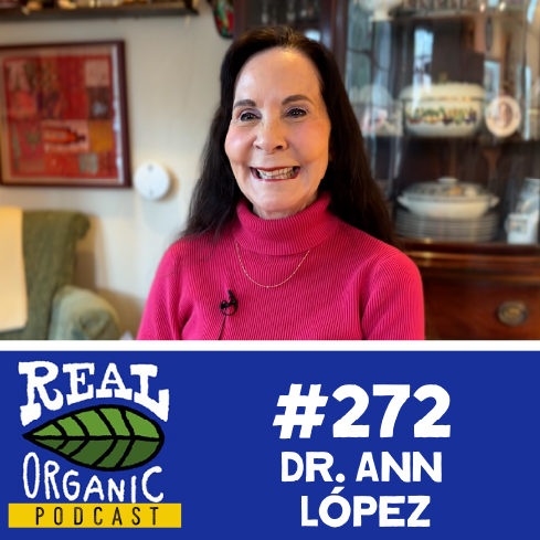 Dr. Ann López smiles in a bright pink turtleneck sweater