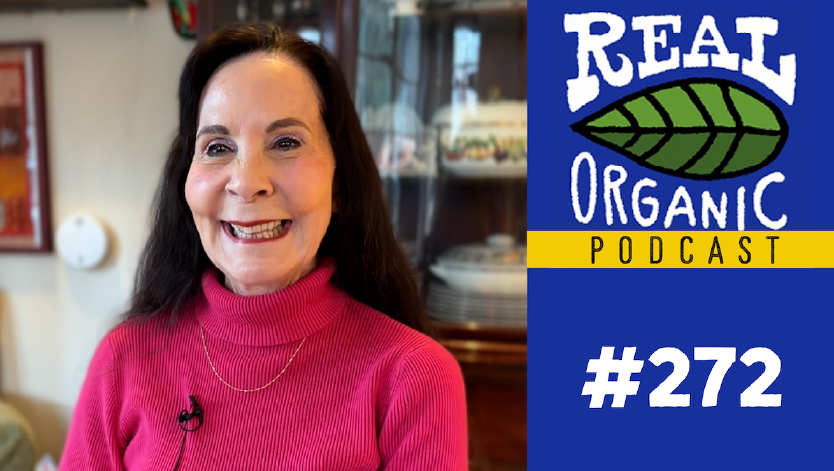 Dr. Ann López smiles in a bright pink turtleneck sweater