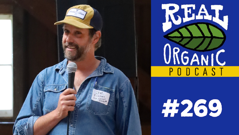 JM Fortier in a denim shirt holding a microphone at Churchtown Dairy