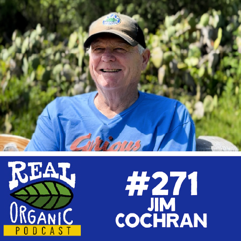 Jim Cochran smiles in a blue curious george t shirt